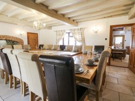 A dining room with a large table and chairs at Stud Farm House in Bleddfa near Knighton