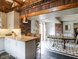 A kitchen with a dining area and wooden furniture at Stud Farm House Bleddfa near Knighton