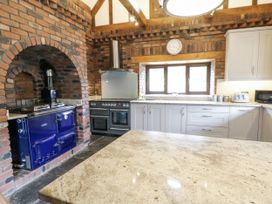 A kitchen with a blue oven and stone countertop at Stud Farm House Bleddfa near Knighton