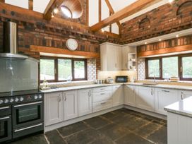 A kitchen with cabinets and appliances at Stud Farm House in Bleddfa near Knighton