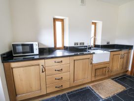 A kitchen with a sink and microwave at Stud Farm House Bleddfa near Knighton