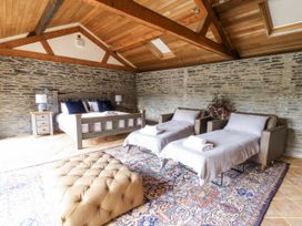 A bedroom with a bed and armchairs at Stud Farm House Bleddfa near Knighton