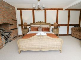 A bedroom with a bed and fireplace at Stud Farm House in Bleddfa near Knighton