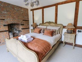 A bedroom with a bed and fireplace at Stud Farm House Bleddfa near Knighton
