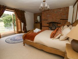 A bedroom with a bed and a view of the outdoors at Stud Farm House Bleddfa near Knighton