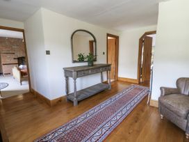 A hallway with a console table and mirror at Stud Farm House Bleddfa near Knighton