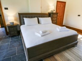 A bedroom with a double bed and nightstand at Stud Farm House Bleddfa near Knighton