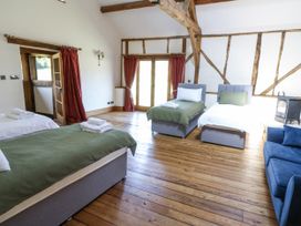 A bedroom with two beds and a sofa at Stud Farm House Bleddfa near Knighton