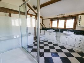A bathroom with bathtub and dual sinks at Stud Farm House Bleddfa near Knighton