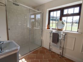 A bathroom with a shower and washbasin at Stud Farm House Bleddfa near Knighton