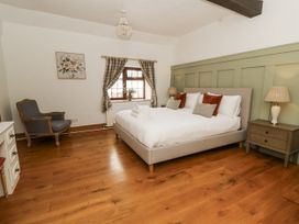 A bedroom with a bed and chair at Stud Farm House Bleddfa near Knighton