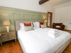 A bedroom with a bed and side table at Stud Farm House Bleddfa near Knighton