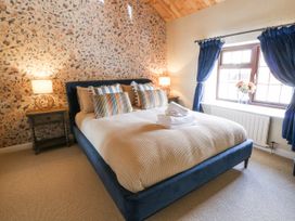 A bedroom with a bed and side table at Stud Farm House in Bleddfa near Knighton