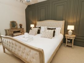 A bedroom with a bed and dresser at Stud Farm House in Bleddfa near Knighton