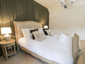 A bedroom with a bed and bedside table at Stud Farm House Bleddfa near Knighton