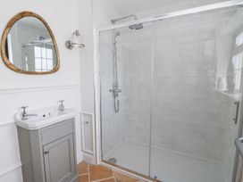 A bathroom with a shower and sink at Stud Farm House in Bleddfa near Knighton