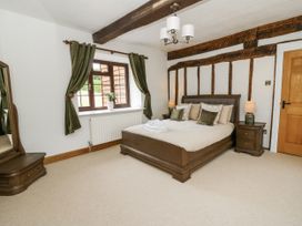 A bedroom with a bed and mirror at Stud Farm House Bleddfa near Knighton