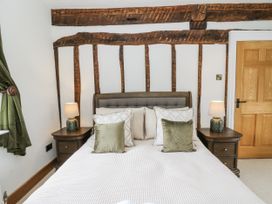 A bedroom with a double bed and bedside tables at Stud Farm House in Bleddfa near Knighton
