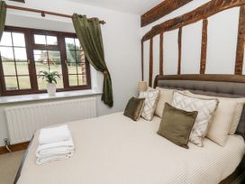 A bedroom with a bed and pillows at Stud Farm House in Bleddfa near Knighton