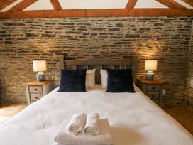 A bedroom with a large bed and bedside tables at Stud Farm House Bleddfa near Knighton