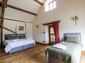 A bedroom with two beds and a window at Stud Farm House in Bleddfa near Knighton