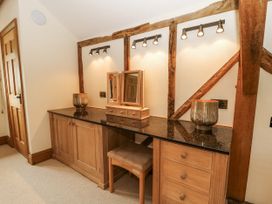A vanity unit with a mirror and drawers at Stud Farm House Bleddfa near Knighton