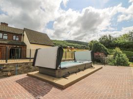 An outdoor area with a hot tub at Stud Farm House Bleddfa near Knighton