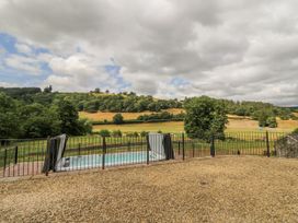 An outdoor area with a swimming pool and a view of hills at Stud Farm House Bleddfa near Knighton