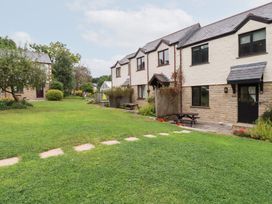 An outdoor area with houses and garden features at Acorns in Falmouth