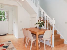A dining room with a table and chairs at Acorns in Falmouth