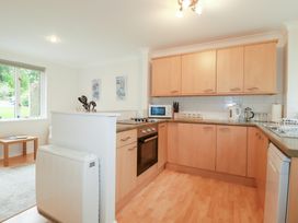 A kitchen with appliances and cabinets at Acorns in Falmouth