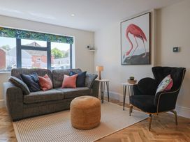 A living room with a sofa and armchair at 1 Mill Green Court Lyme Regis