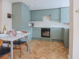 A kitchen with a dining table and chairs at 1 Mill Green Court Lyme Regis