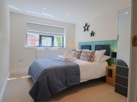 A bedroom with a bed and bedside table at 1 Mill Green Court Lyme Regis