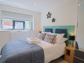 A bedroom with a bed and window at 1 Mill Green Court Lyme Regis