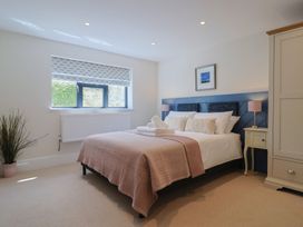 A bedroom with a bed and nightstand at 1 Mill Green Court Lyme Regis