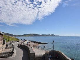 A coastal view with a beach and path at 1 Mill Green Court in Lyme Regis