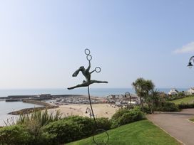 A sculpture overlooking the beach and harbor at 1 Mill Green Court Lyme Regis