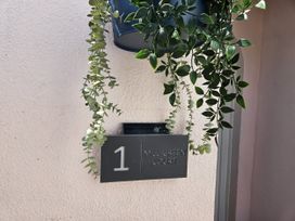 A sign with the number 1 and the name Mill Green Court at 1 Mill Green Court Lyme Regis