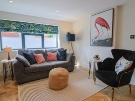 A living room with a sofa and lamp at 1 Mill Green Court Lyme Regis
