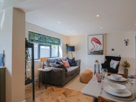 A living room with a sofa and dining table at 1 Mill Green Court Lyme Regis