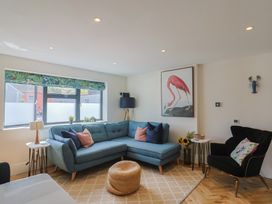 A living room with a sofa and artwork at 1 Mill Green Court Lyme Regis
