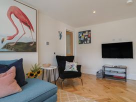 A living room with a television and artwork at 1 Mill Green Court in Lyme Regis