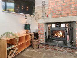 A living room with a fireplace and television at Sea Haven Hunmanby Gap near Primrose Valley