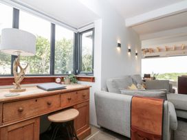 A living room with a desk and sofa at Sea Haven in Hunmanby Gap near Primrose Valley