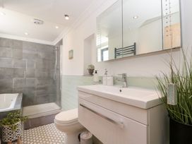A bathroom with a shower and bathtub at Sea Haven Hunmanby Gap near Primrose Valley