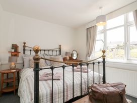 A bedroom with a bed and bedside table at Sea Haven near Primrose Valley