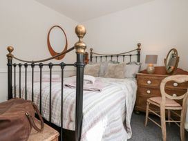 A bedroom with a bed and dresser at Sea Haven in Hunmanby Gap near Primrose Valley
