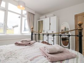 A bedroom with a bed and wardrobe at Sea Haven Hunmanby Gap near Primrose Valley