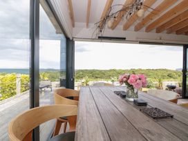 A dining room with a wooden table and chairs at Sea Haven in Hunmanby Gap near Primrose Valley
